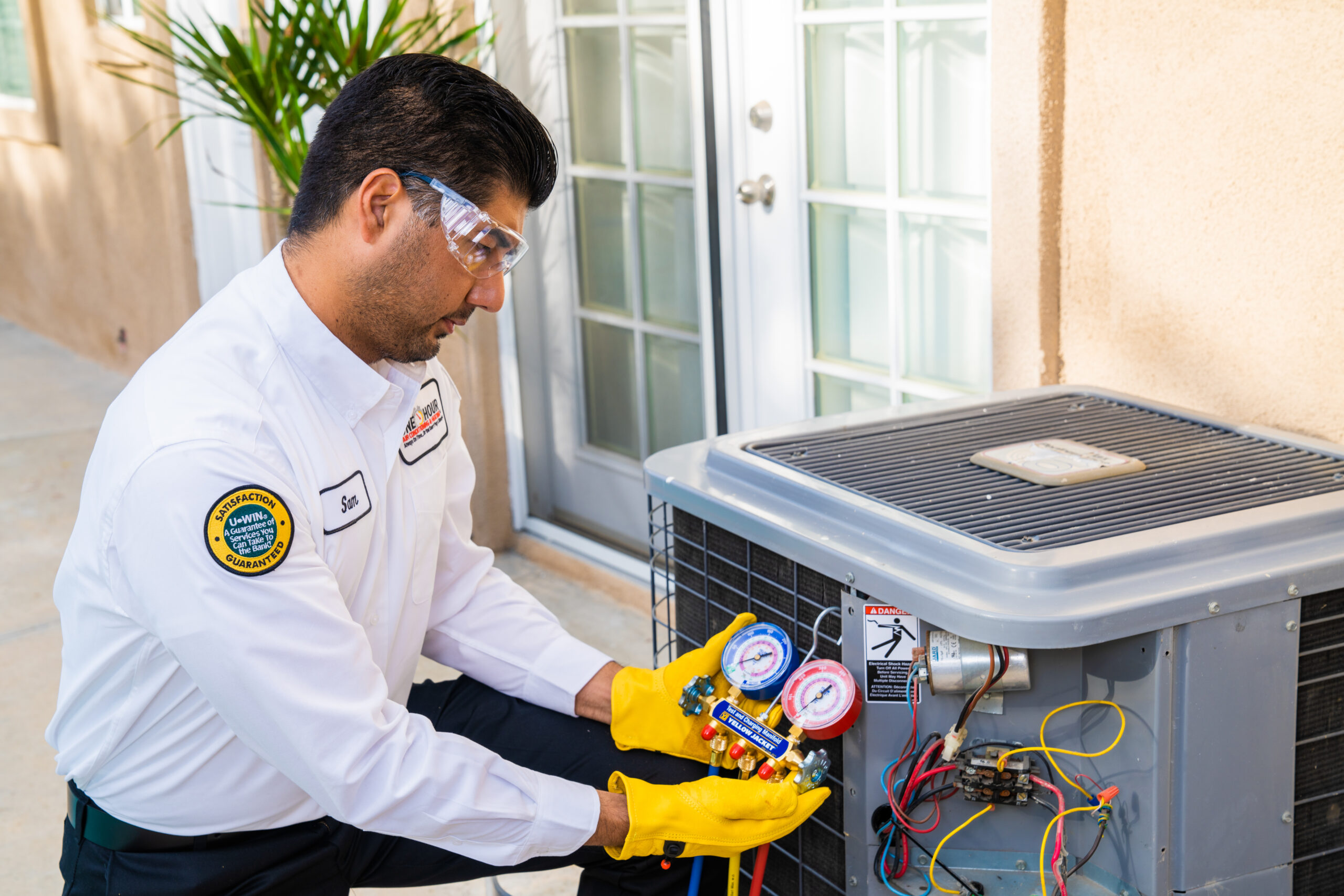 A technician doing maintenance on an AC unit